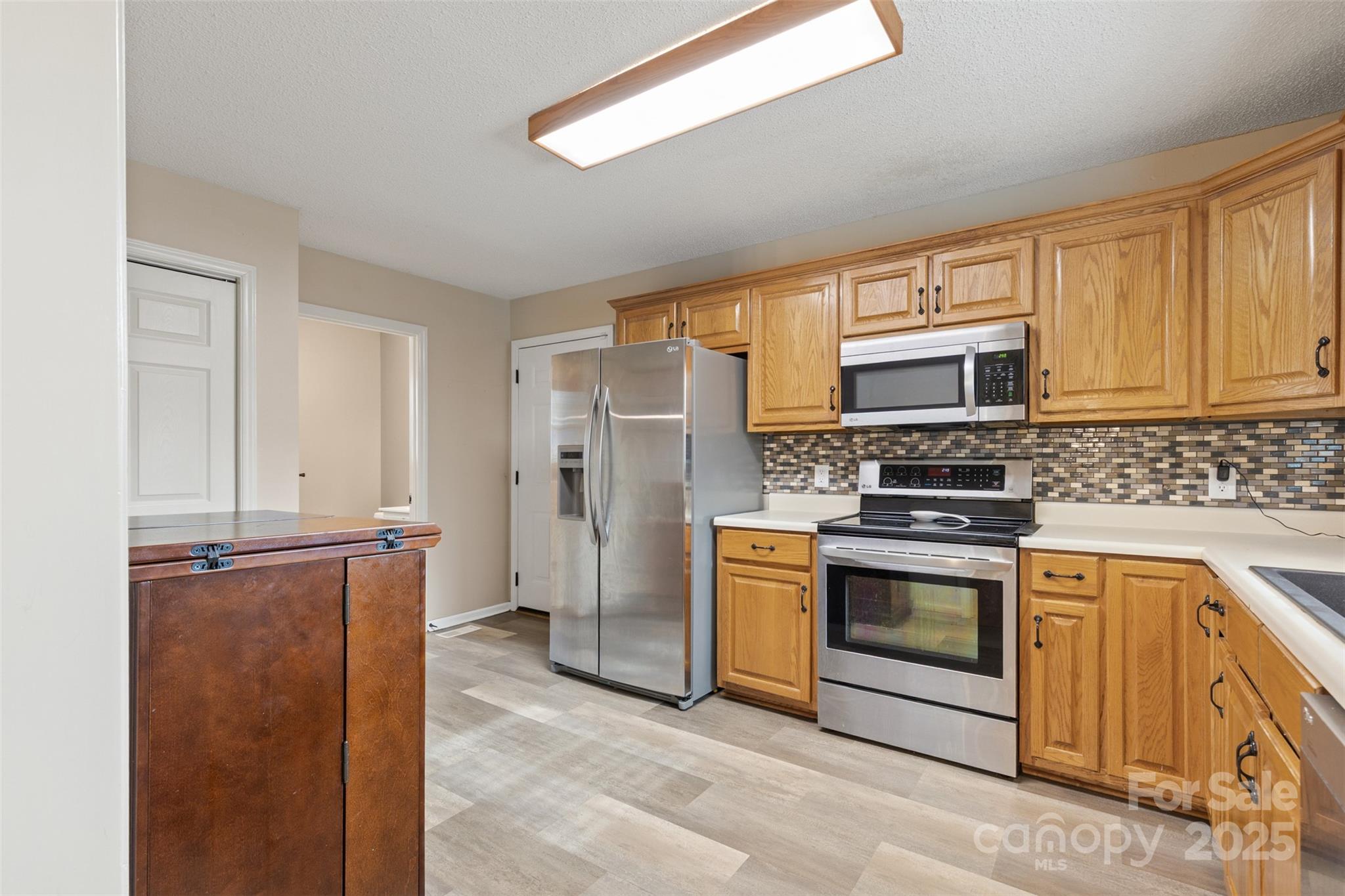 3233 6th Avenue Northeast Conover, NC 28613 - Photo 7 of 30 a kitchen with stainless steel appliances granite countertop a refrigerator stove and sink