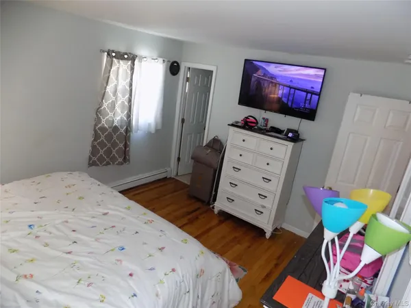 a bedroom with a bed and flat screen tv