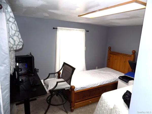 a bedroom with furniture and wooden floor