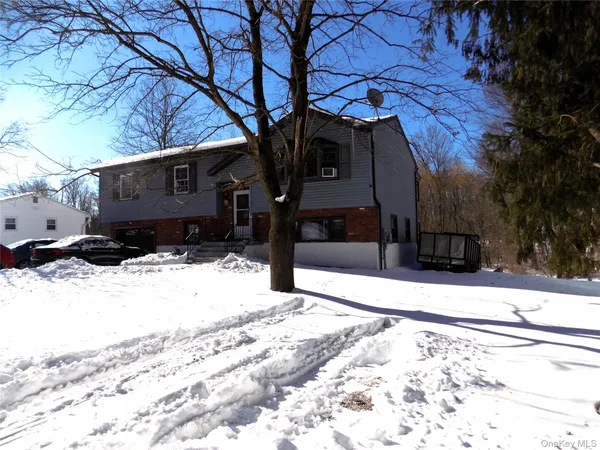 a view of a house with snow on the road