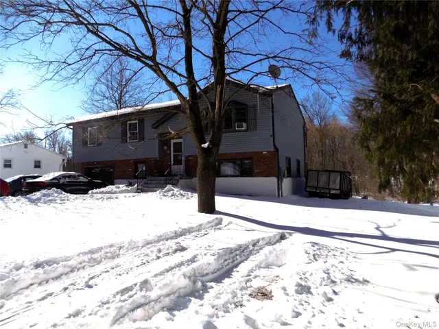 a view of a house with snow on the road
