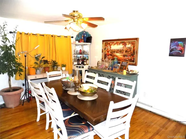 a view of a dining room with furniture a chandelier and wooden floor
