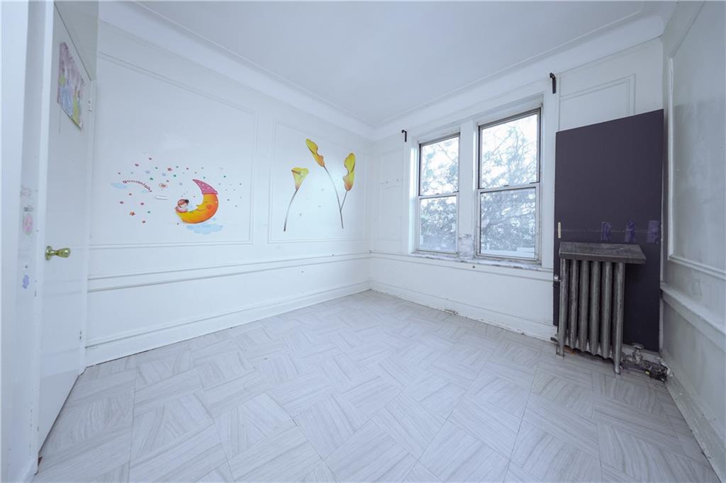 729 59th Street Brooklyn, NY 11220 - Photo 24 of 36 a view of an empty room with a window