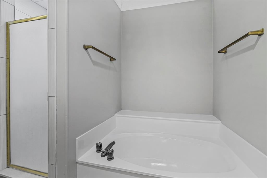 4017 St Christopher Lane Dallas, TX 75287 - Photo 14 of 16 a bathroom with a bathtub