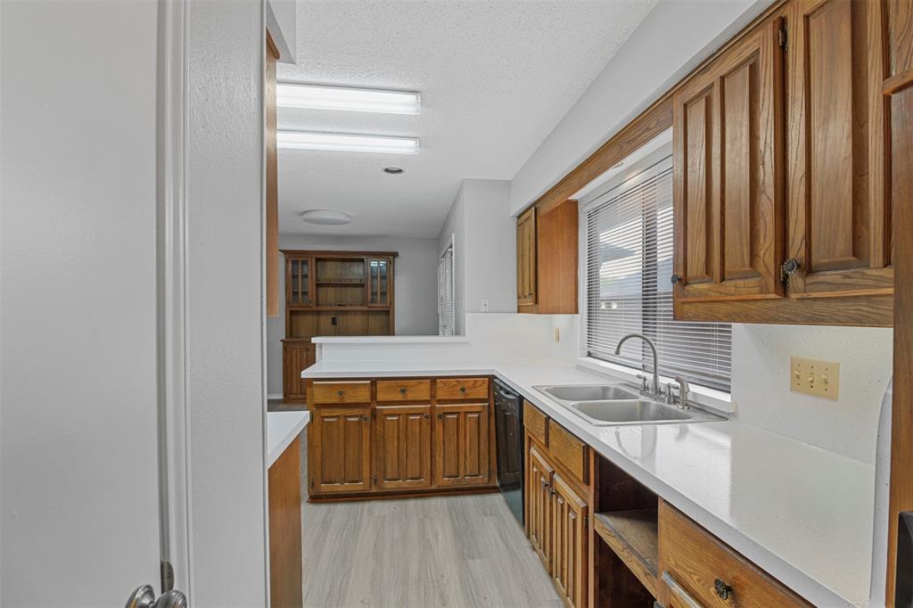 4017 St Christopher Lane Dallas, TX 75287 - Photo 3 of 16 a kitchen with a sink and a refrigerator