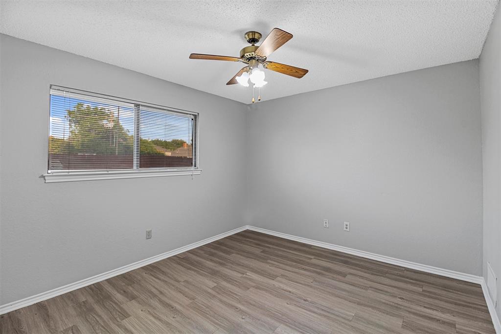 4017 St Christopher Lane Dallas, TX 75287 - Photo 8 of 16 wooden floor in an empty room with a window