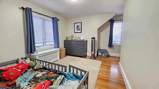 a bedroom with furniture and a window