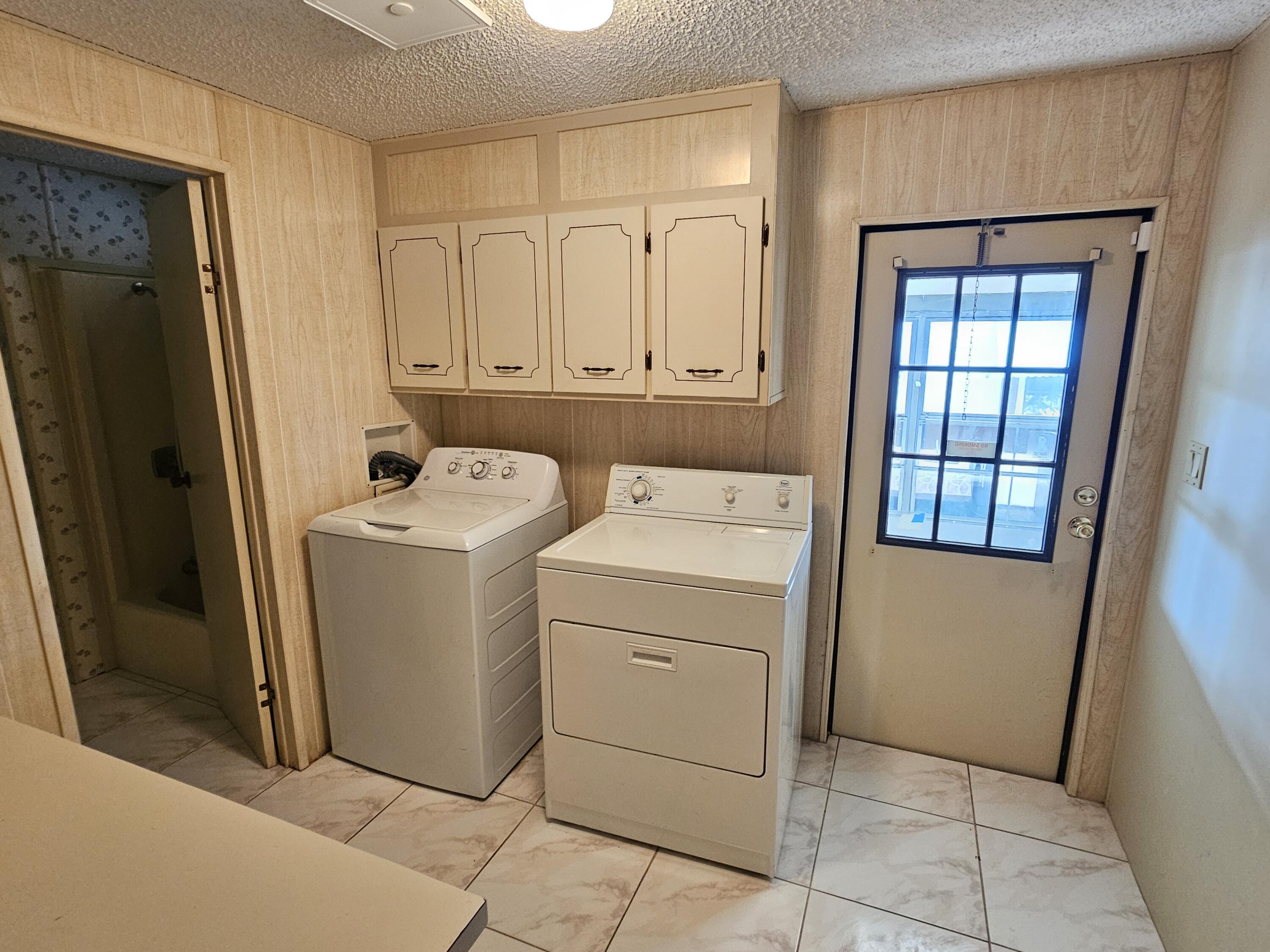 6978 Southeast Delegate Street Hobe Sound, FL 33455 - Photo 14 of 24 a utility room with dryer and washer