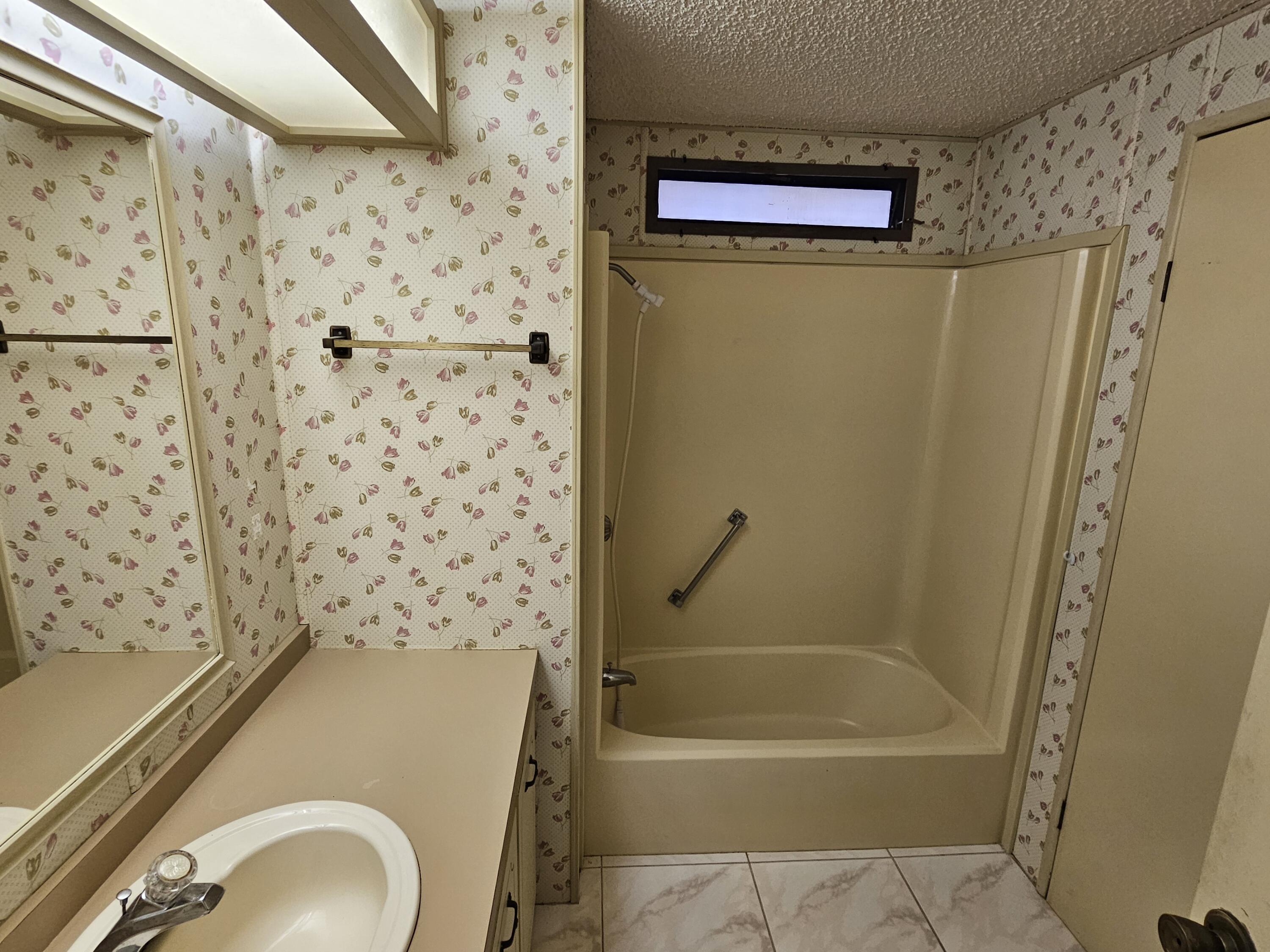 6978 Southeast Delegate Street Hobe Sound, FL 33455 - Photo 17 of 24 a bathroom with a toilet and a bathtub