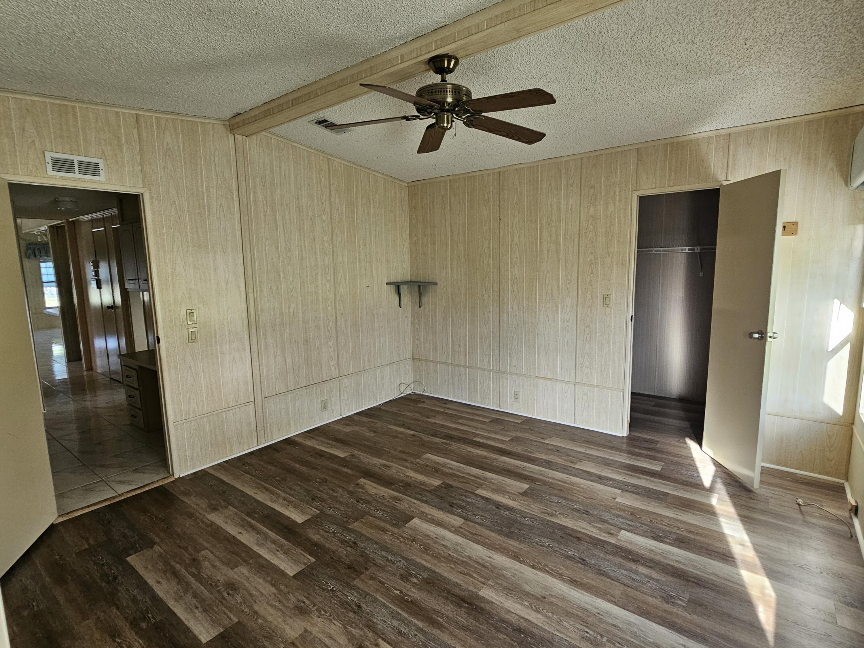 6978 Southeast Delegate Street Hobe Sound, FL 33455 - Photo 21 of 24 a view of empty room with wooden floor