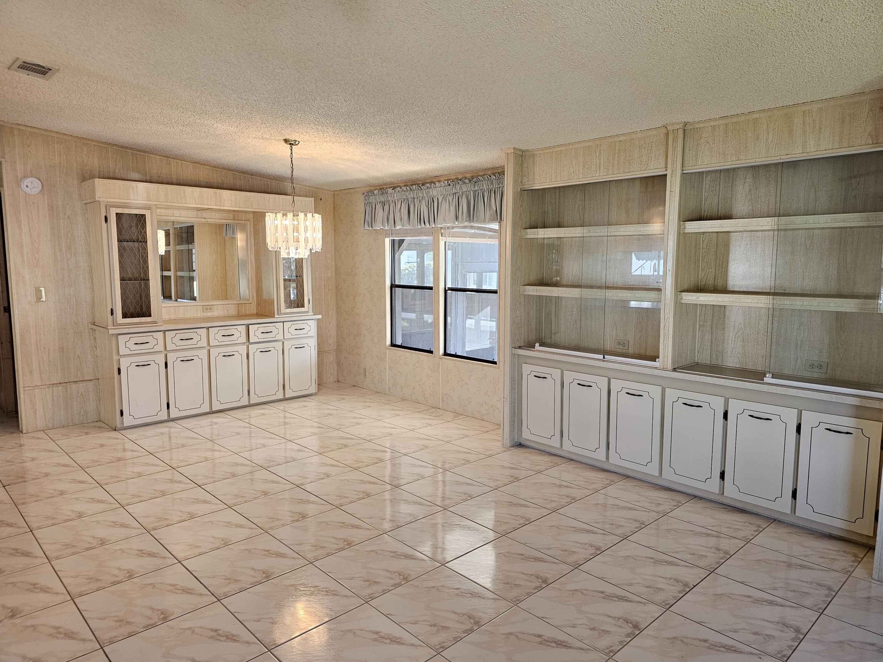 6978 Southeast Delegate Street Hobe Sound, FL 33455 - Photo 7 of 24 a large white room with windows