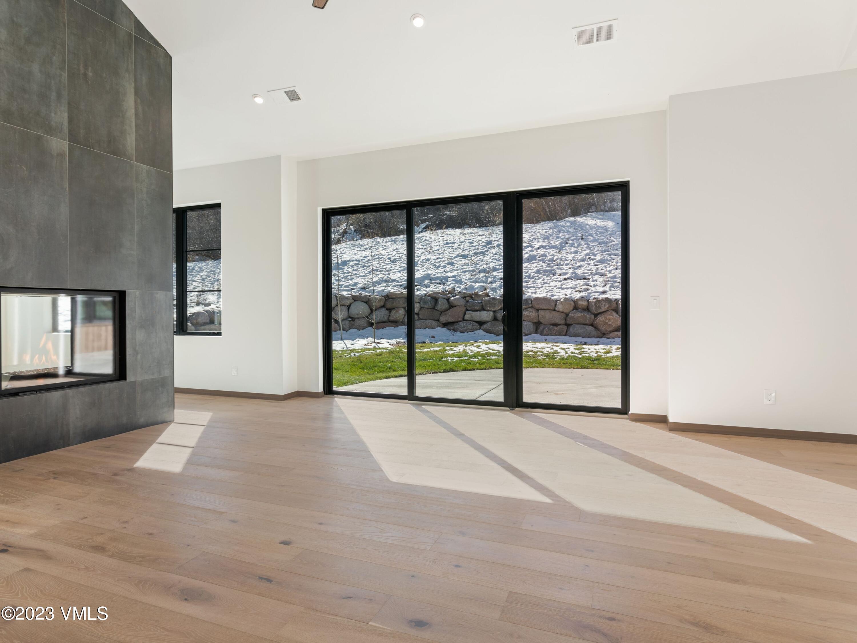2494 Eagle Ranch Road Eagle, CO 81631 - Photo 12 of 49 a view of an empty room with a fireplace and a window