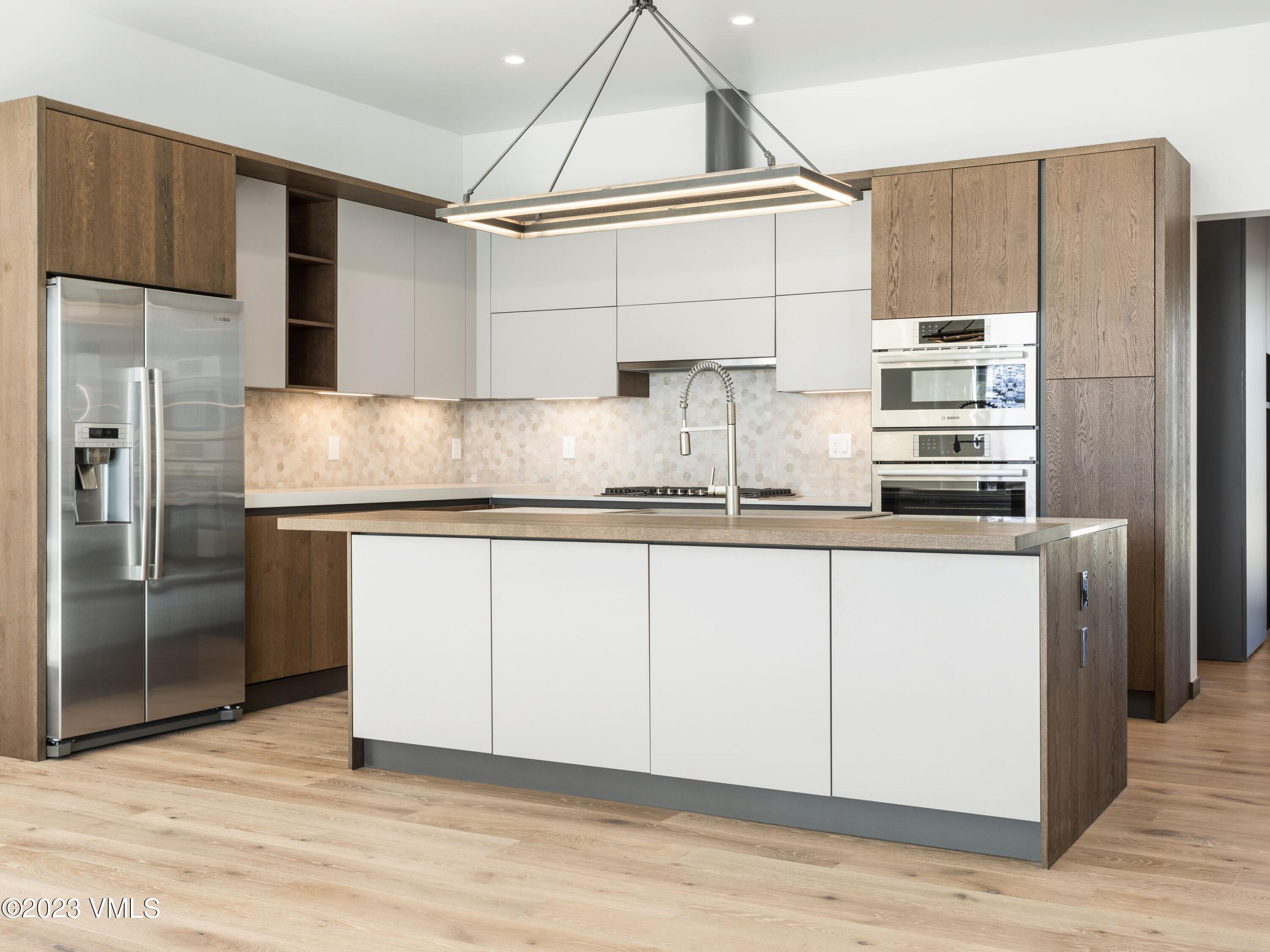 2494 Eagle Ranch Road Eagle, CO 81631 - Photo 13 of 49 a kitchen with stainless steel appliances granite countertop a refrigerator and a sink