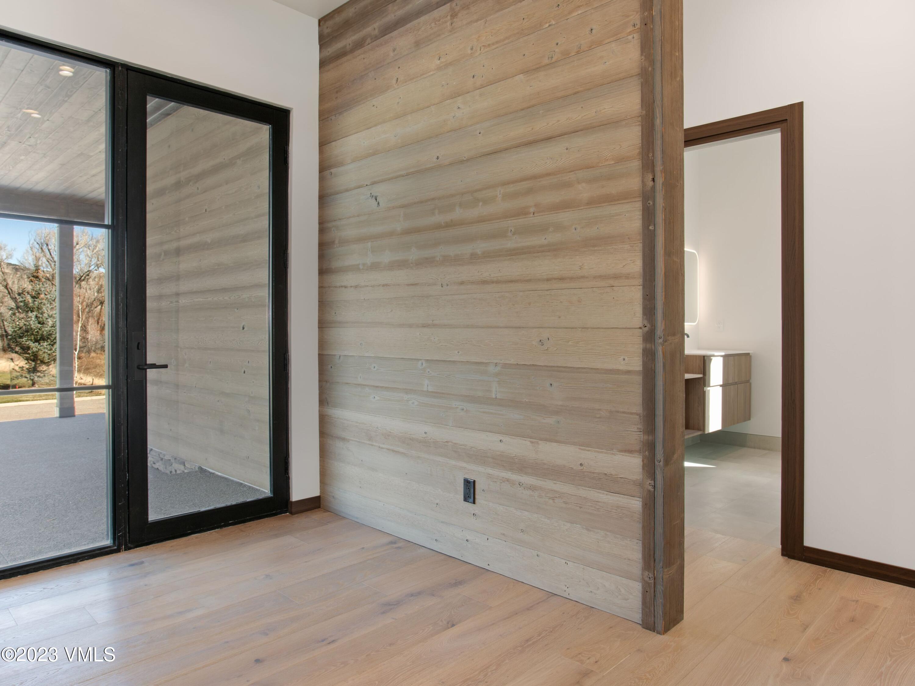 2494 Eagle Ranch Road Eagle, CO 81631 - Photo 38 of 49 an empty room with wooden floor and windows