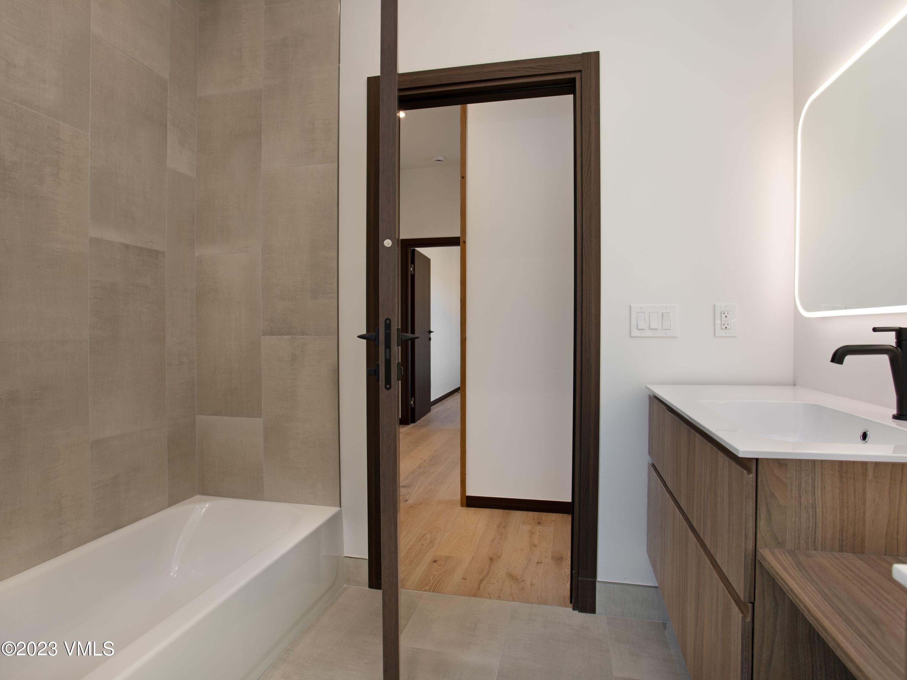 2494 Eagle Ranch Road Eagle, CO 81631 - Photo 40 of 49 a bathroom with a granite countertop sink and a bathtub
