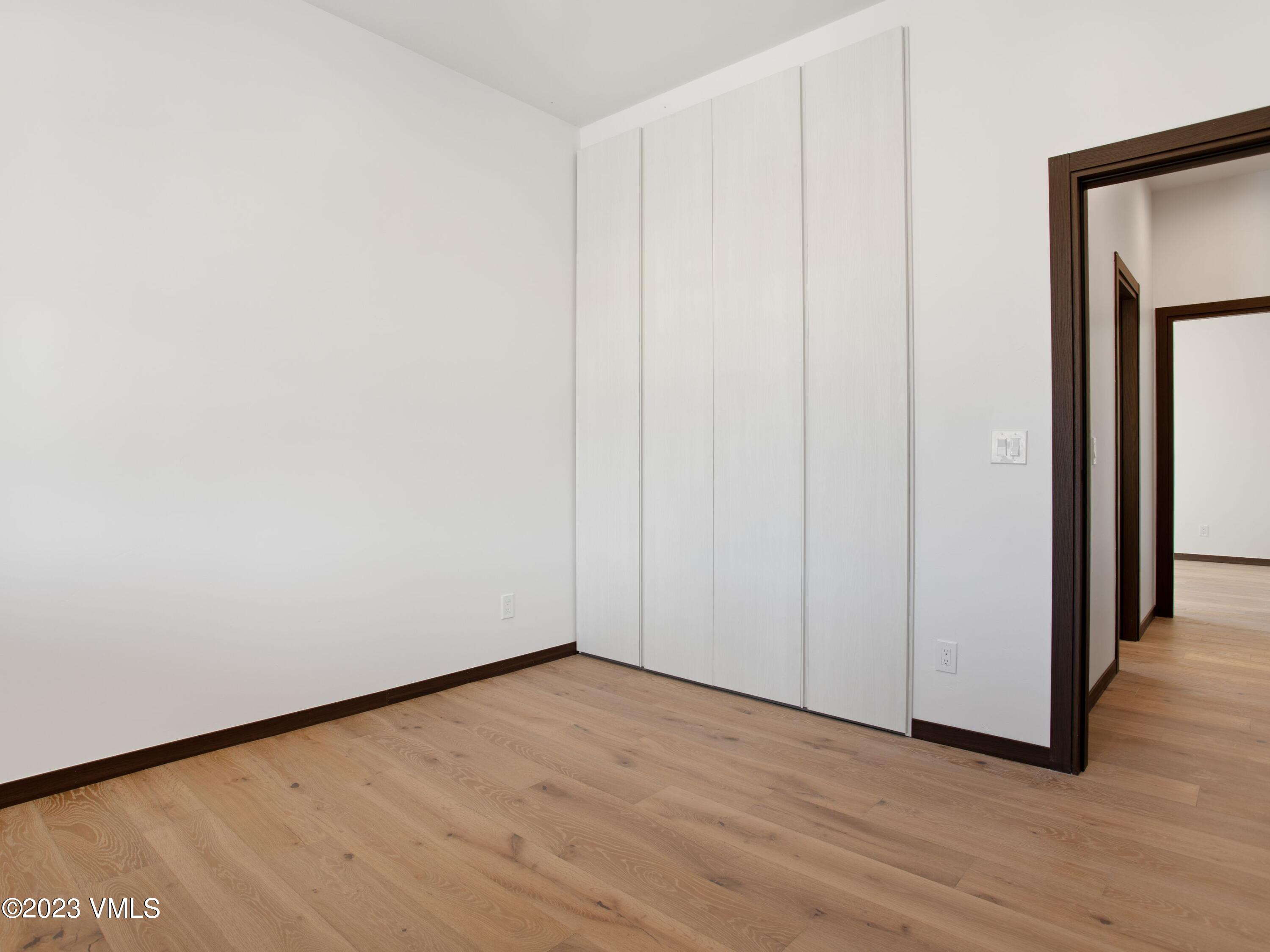 2494 Eagle Ranch Road Eagle, CO 81631 - Photo 41 of 49 a view of an empty room with wooden floor