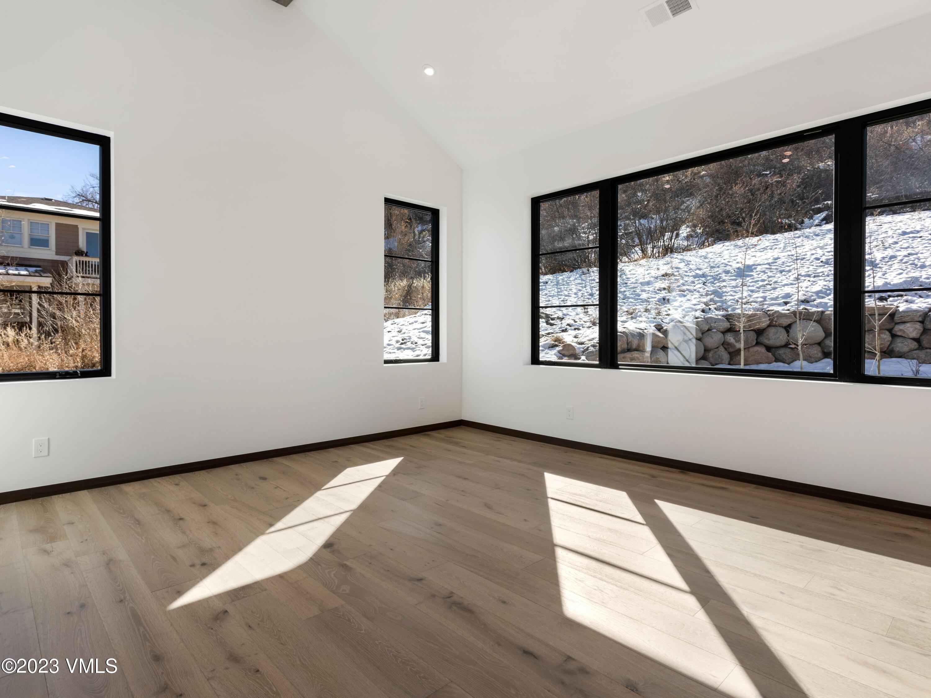 2494 Eagle Ranch Road Eagle, CO 81631 - Photo 5 of 49 a view of an empty room with wooden floor and a window