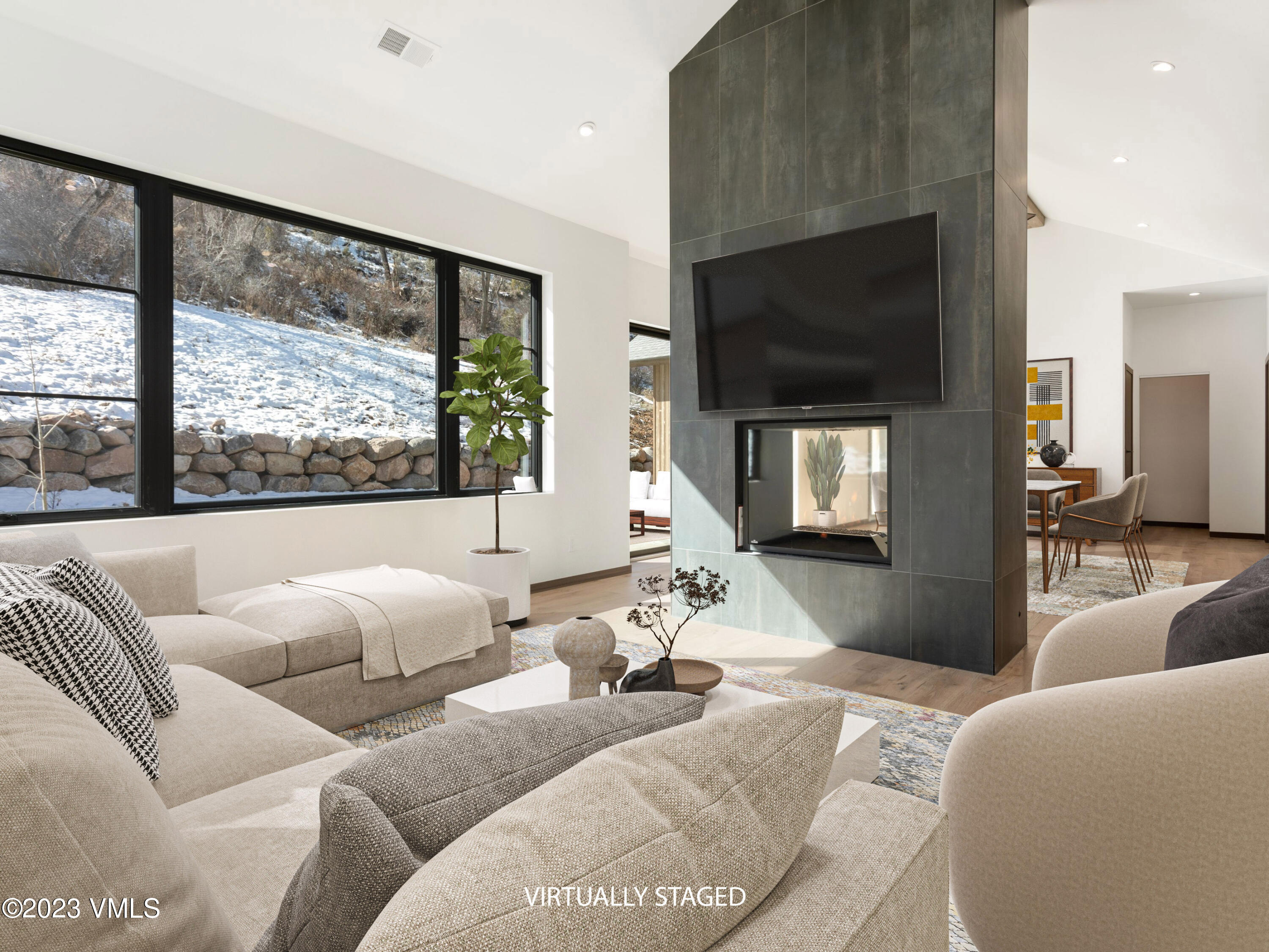 2494 Eagle Ranch Road Eagle, CO 81631 - Photo 6 of 49 a living room with furniture a flat screen tv and a large window