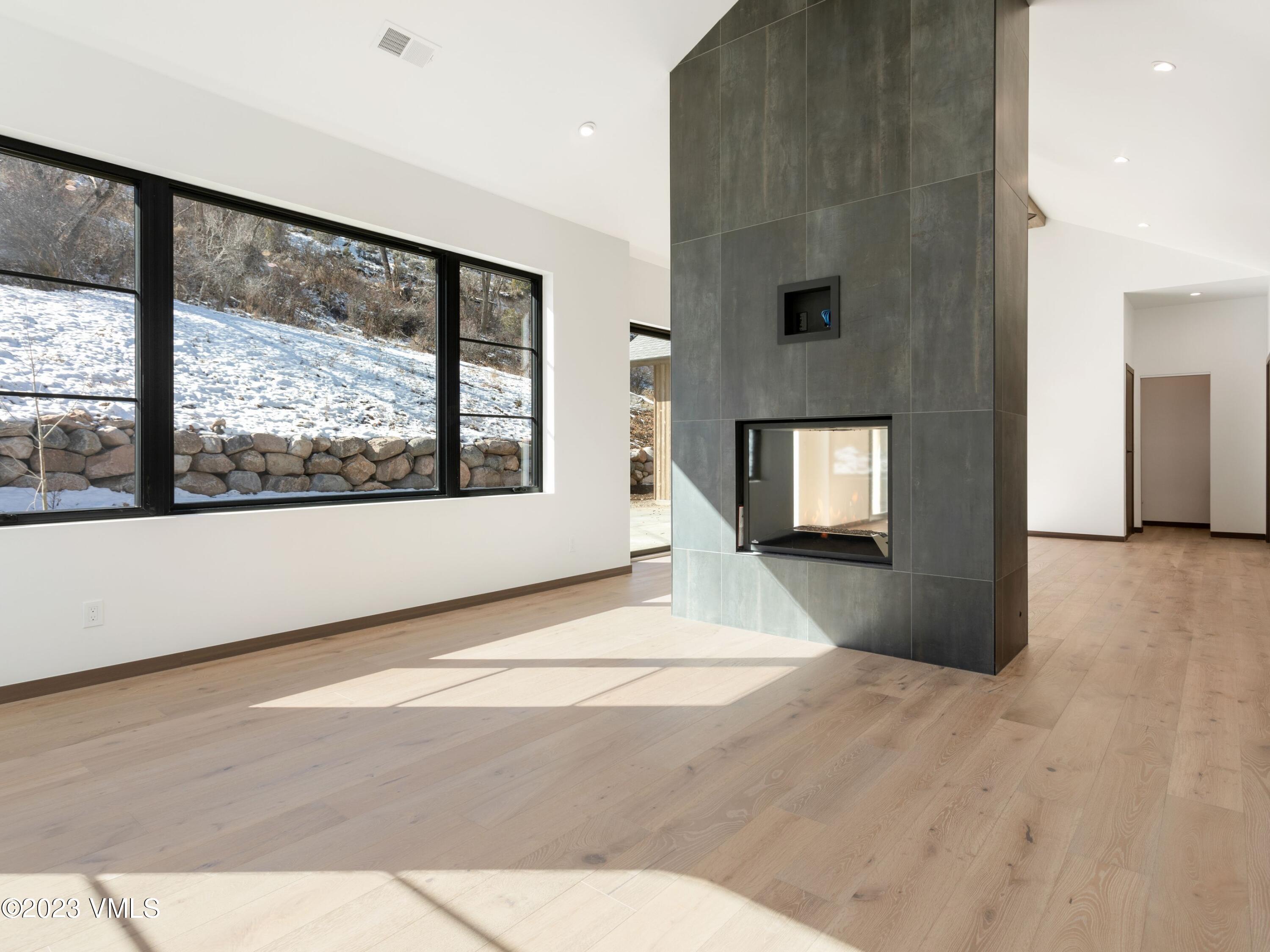 2494 Eagle Ranch Road Eagle, CO 81631 - Photo 7 of 49 a view of an empty room with a window and a kitchen