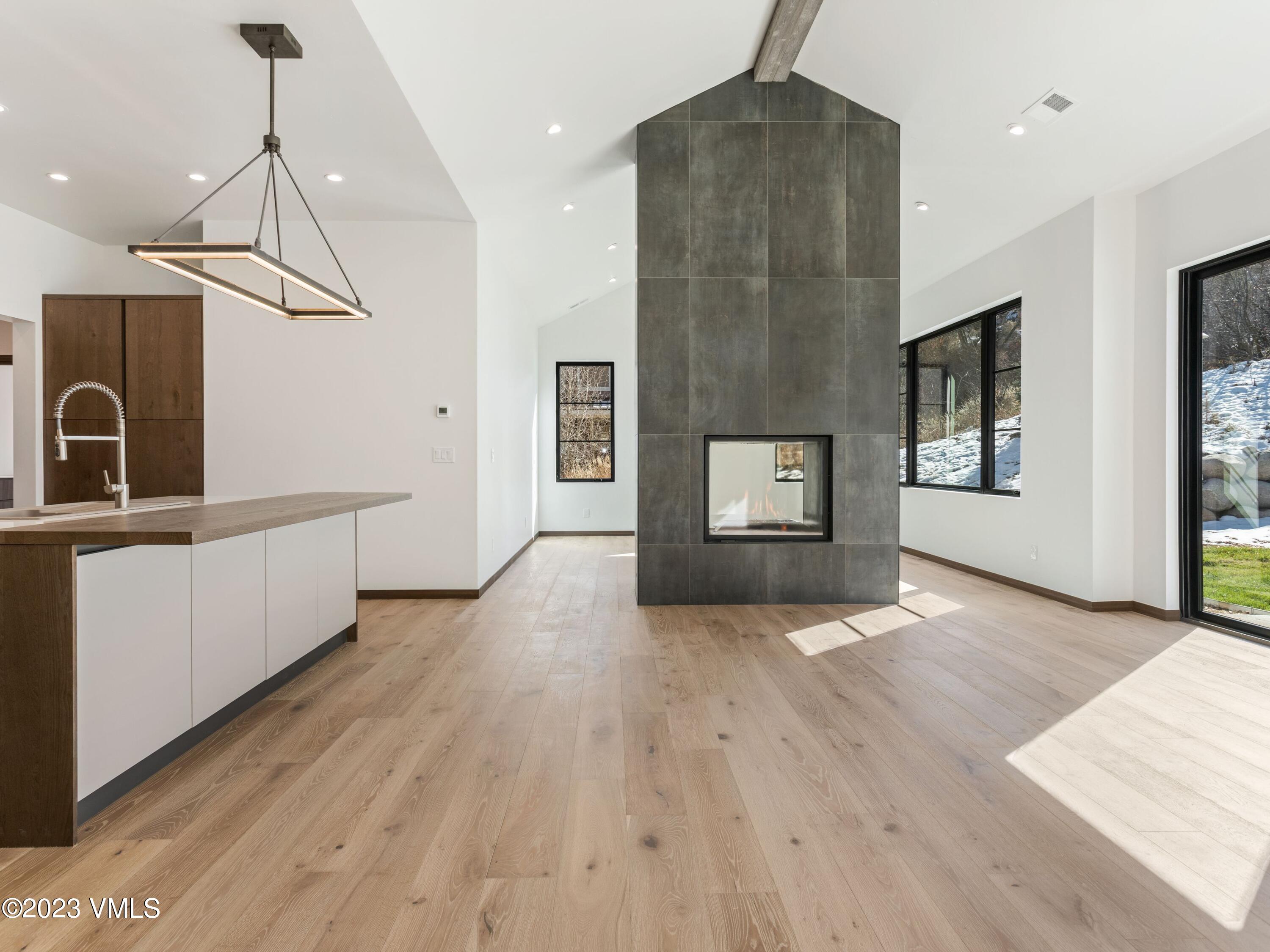 2494 Eagle Ranch Road Eagle, CO 81631 - Photo 9 of 49 a view of a hallway with wooden floor and staircase
