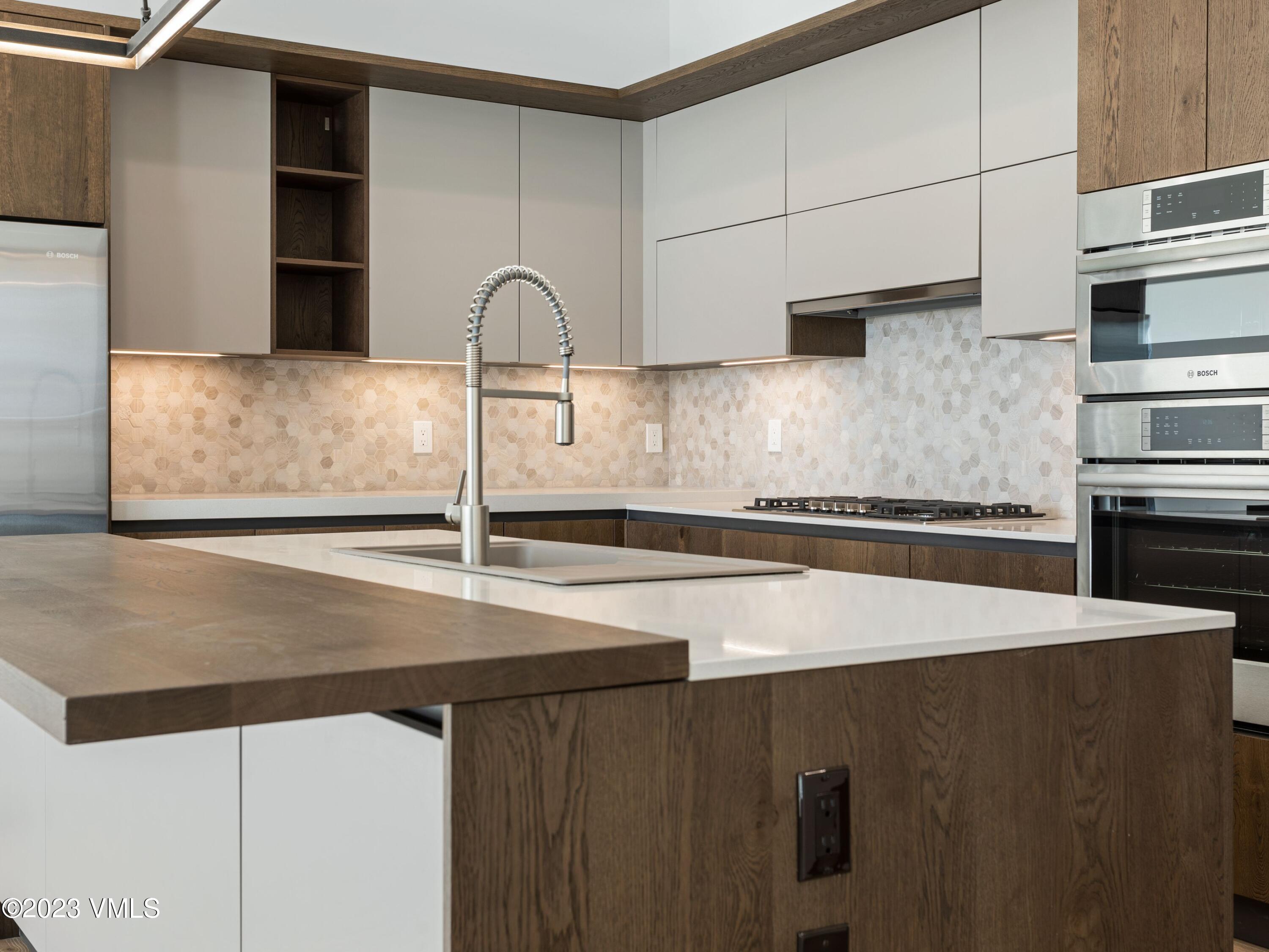 2494 Eagle Ranch Road Eagle, CO 81631 - Photo 10 of 49 a kitchen with granite countertop a refrigerator and a sink