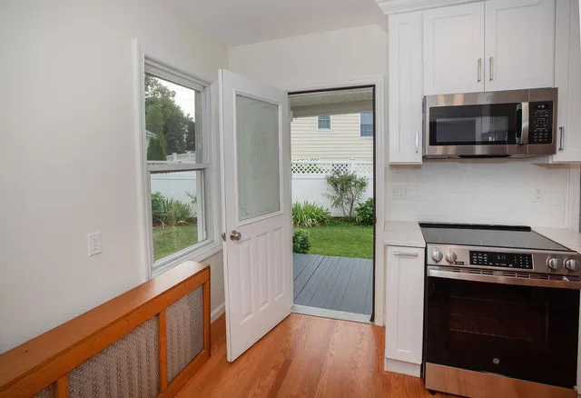 a view of kitchen and microwave with wooden floor