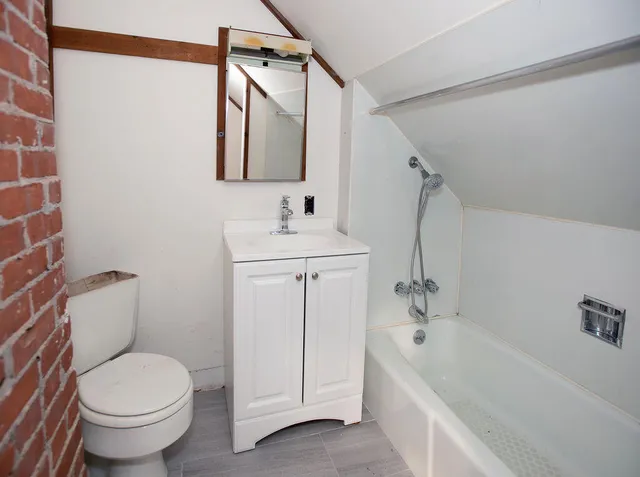 a view of a hallway view with wooden floor and staircase