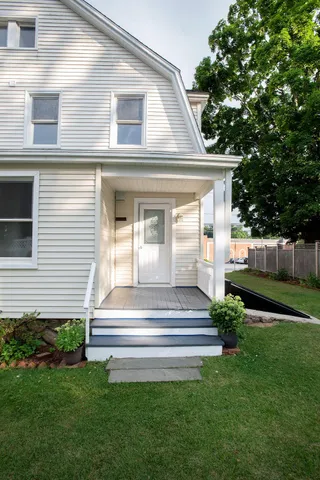a front view of a house with a garden