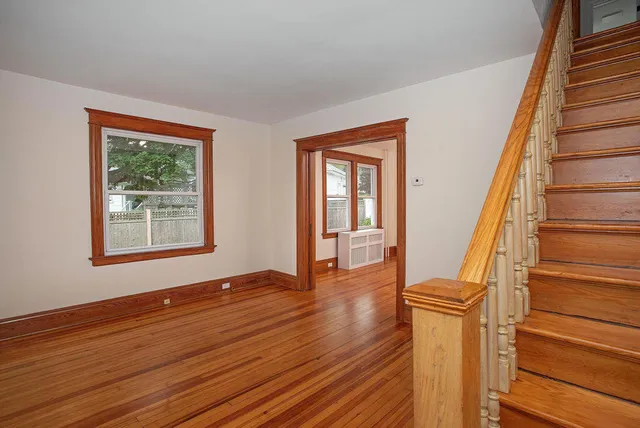 a view of an entryway with wooden floor and door