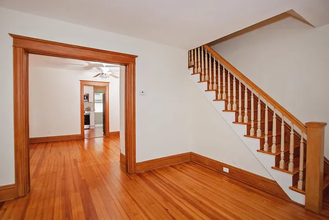 a view of front door with wooden floor and stairs
