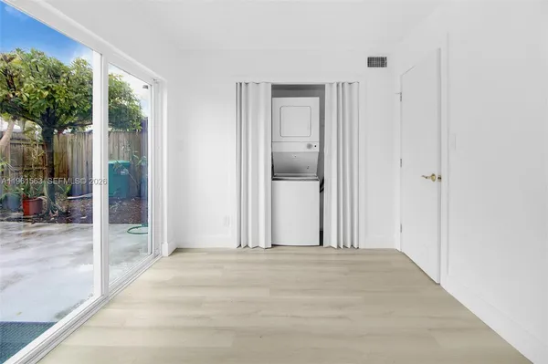 a view of a hallway with wooden floor and plants