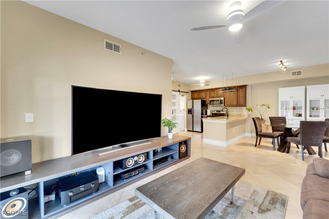 6450 Aragon Way, Unit 202 Fort Myers, FL 33966 - Photo 18 of 24 a living room with furniture and a flat screen tv