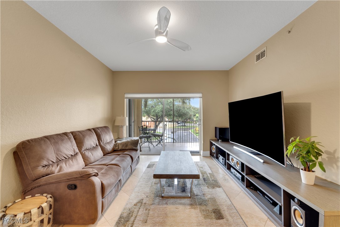 6450 Aragon Way, Unit 202 Fort Myers, FL 33966 - Photo 20 of 24 a living room with furniture and a flat screen tv