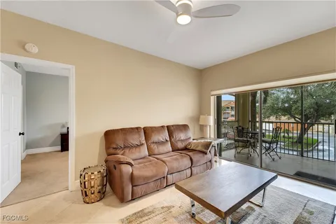 a living room with furniture a table and a large window