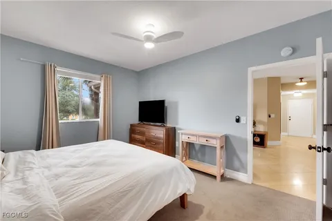 a bedroom with a bed and a tv