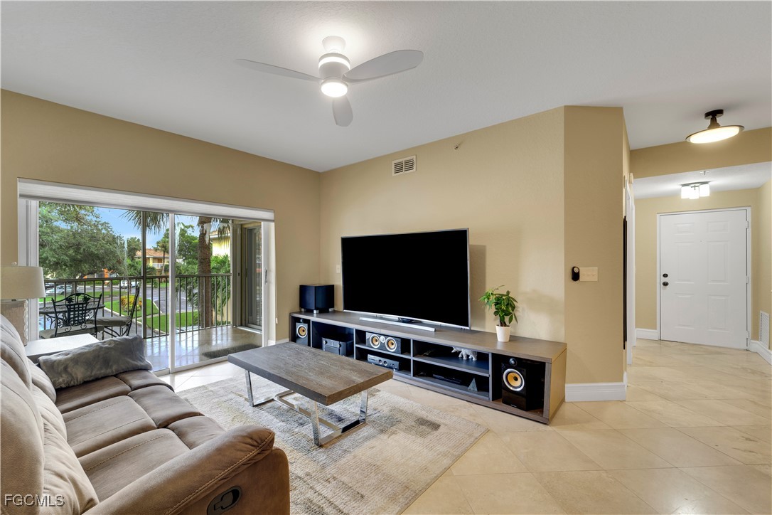6450 Aragon Way, Unit 202 Fort Myers, FL 33966 - Photo 4 of 24 a living room with furniture and a flat screen tv