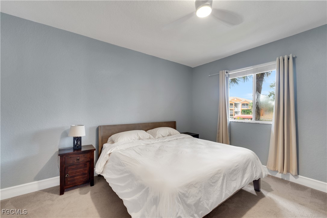 6450 Aragon Way, Unit 202 Fort Myers, FL 33966 - Photo 5 of 24 a bedroom with a bed and a window