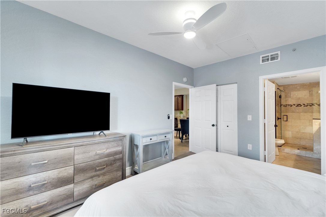 6450 Aragon Way, Unit 202 Fort Myers, FL 33966 - Photo 6 of 24 a bedroom with a bed and a flat screen tv