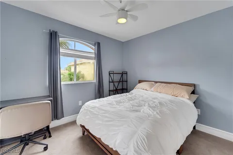 a bed sitting in a bedroom next to a window