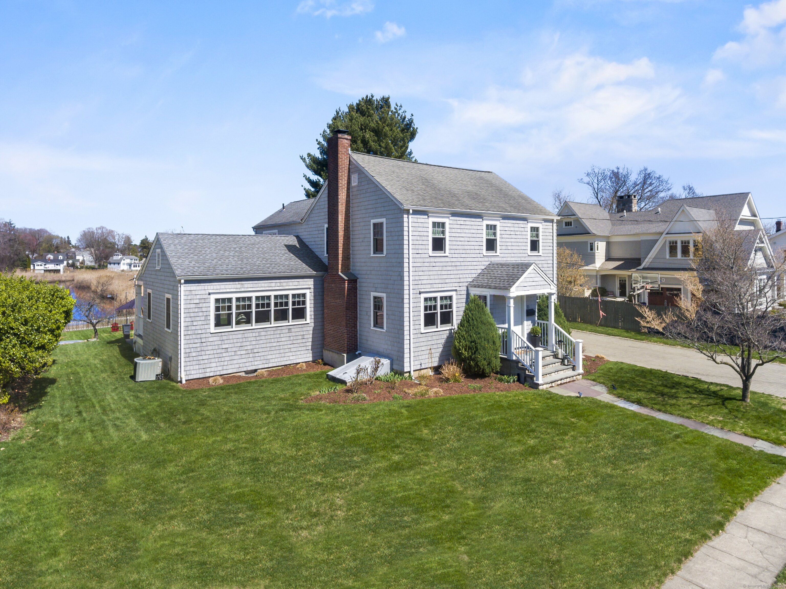 a view of a house with backyard and porch