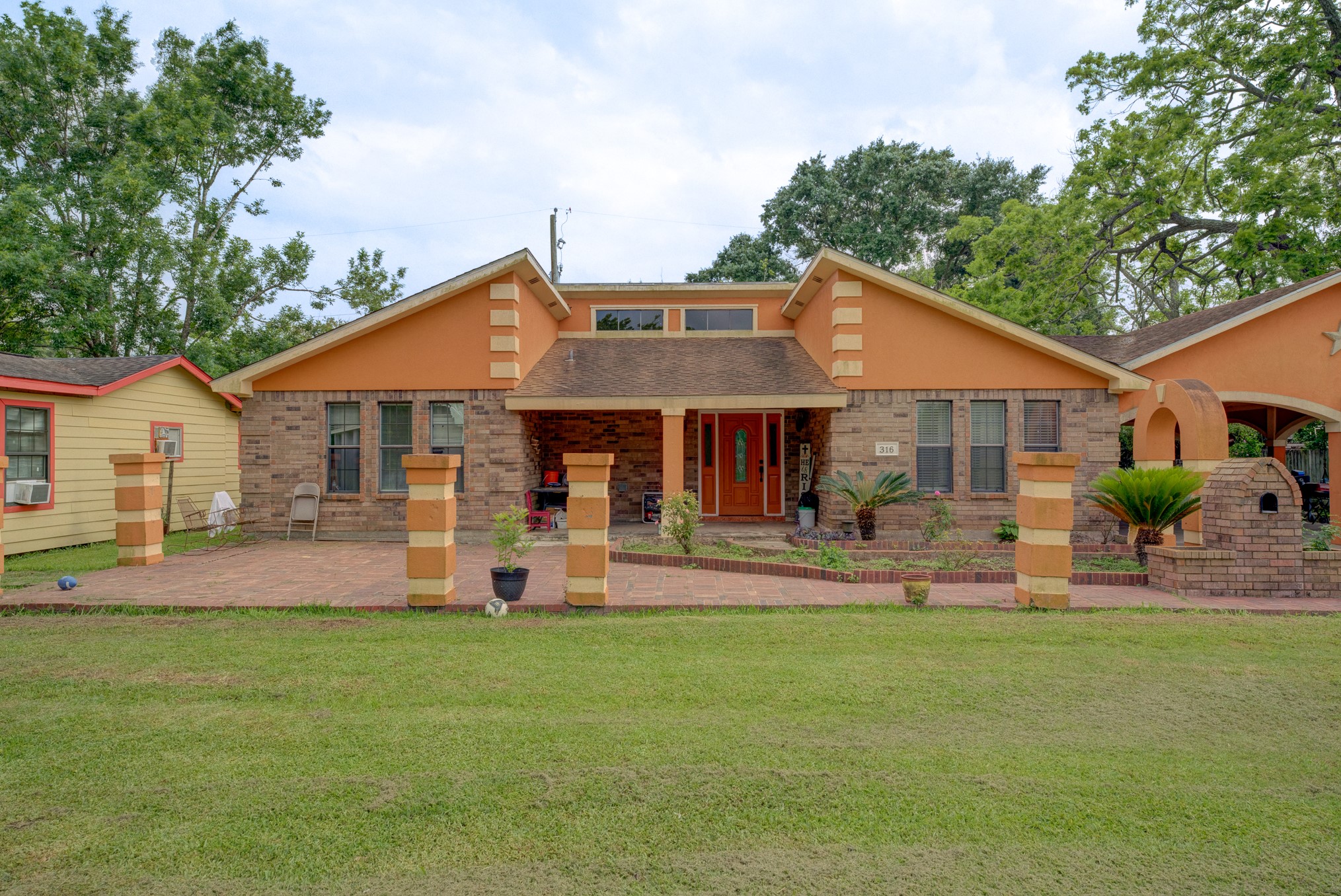 a front view of house with yard and outdoor seating