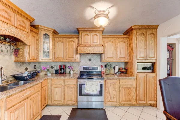 a kitchen with stainless steel appliances granite countertop a stove and cabinets