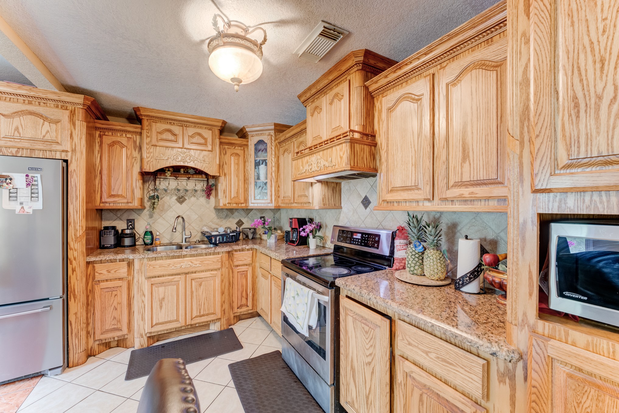 316 Hickman Lane Angleton, TX 77515 - Photo 13 of 48 a kitchen with stainless steel appliances granite countertop a stove and a sink