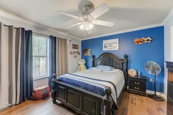 a bedroom with a bed and a chandelier