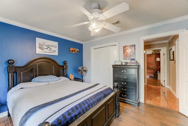 a bedroom with a bed and a chandelier