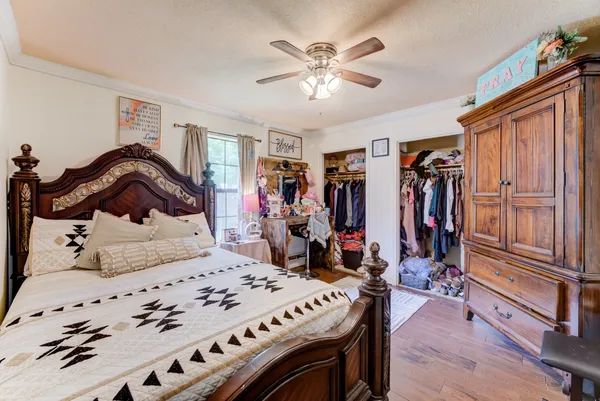 a bedroom with a bed and a chandelier