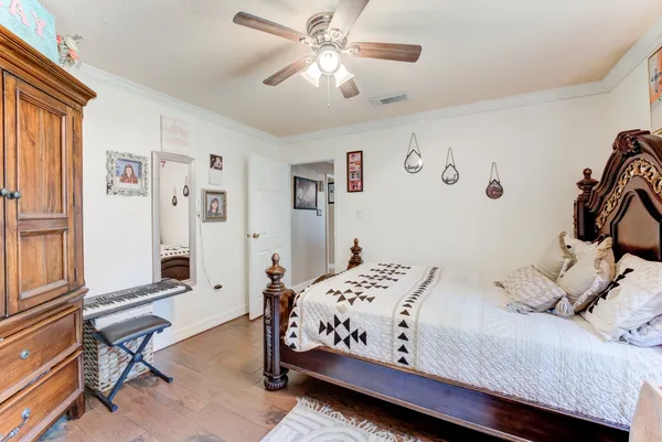 a bedroom with a bed and a chandelier