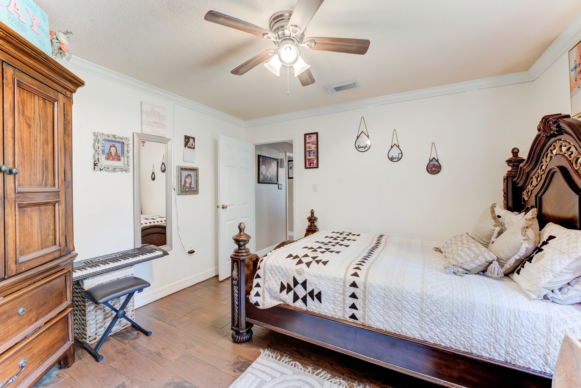 316 Hickman Lane Angleton, TX 77515 - Photo 27 of 48 a bedroom with a bed and a chandelier