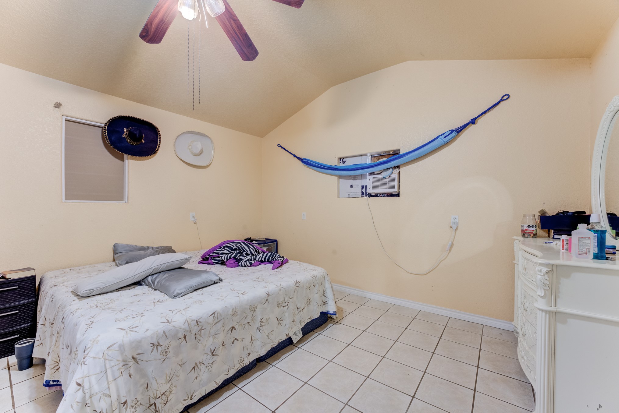 316 Hickman Lane Angleton, TX 77515 - Photo 28 of 48 a bedroom with a bed and a chandelier