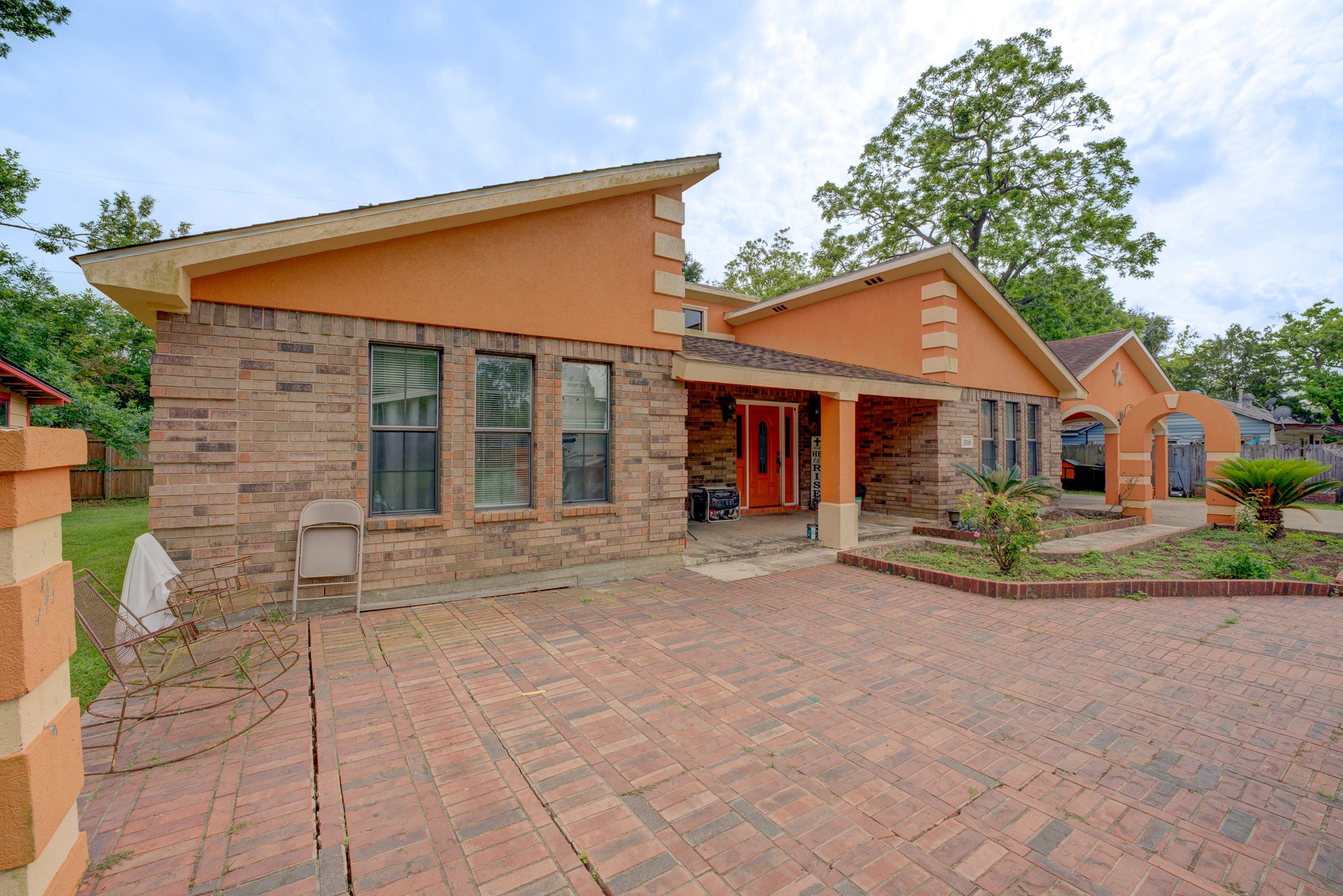 316 Hickman Lane Angleton, TX 77515 - Photo 43 of 48 a front view of a house with a garden and outdoor seating